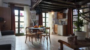 a kitchen and living room with a table and chairs at Ifigenia Rooms in Chania +53 photos