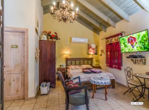 a bedroom with a bed and a table and chairs at Zemer Lodging in Sede Eli‘ezer