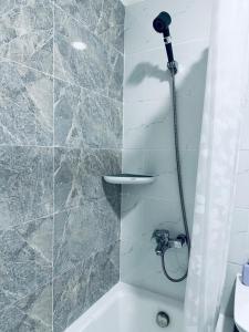 a bathroom with a shower with a bath tub at Comfy apartment near central train station in Ulaanbaatar +23 photos