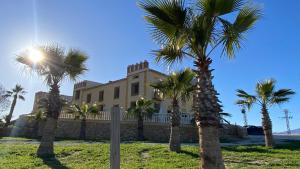 a house with palm trees in front of it at Mirador de Aledo in Aledo