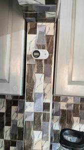 a bathroom with a toilet and a tile floor at llc APARTMENT in Kumasi +27 photos