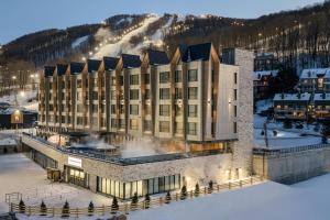 an aerial view of a hotel in the snow at Residence Inn by Marriott Bromont in Bromont