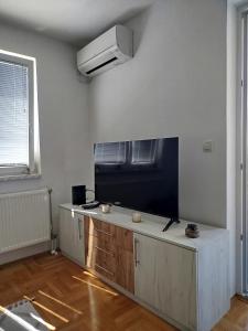a living room with a large flat screen tv on the wall at Smjestaj_S in Bijeljina