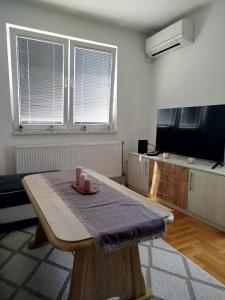 a living room with a table with candles on it at Smjestaj_S in Bijeljina +4 photos