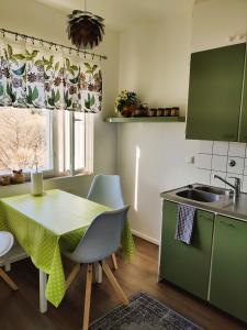 a kitchen with a table and a sink and a table at Yyterin Kontu in Pori