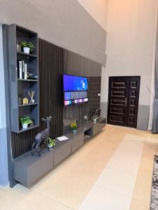 a living room with a tv on a wall at llc APARTMENT in Kumasi