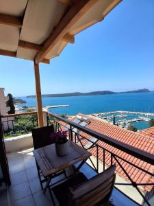 a balcony with a table and chairs and a view of the water at Bay blue in Pylos