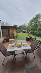 a table and two chairs on a patio at Glossy Messinian Escape - Cozy Yard Apartment in Filiatra