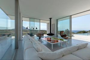 a living room with a white couch and a table at Villa Paleopoli in Kythira