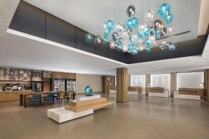 a lobby with a table and chairs and a chandelier at Fairfield by Marriott Hengdian in Dongyang