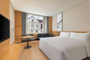 a hotel room with a bed and a window at Fairfield by Marriott Hengdian in Dongyang