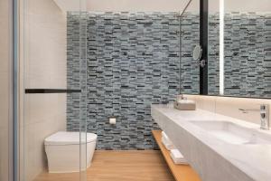 a bathroom with a sink and a toilet at Fairfield by Marriott Hengdian in Dongyang +23 photos