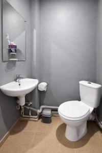 a bathroom with a white toilet and a sink at Guest House Asahi in Stryi +17 photos