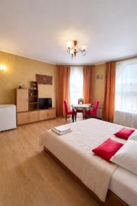 a large bedroom with a large bed and a table at Guest House Asahi in Stryi