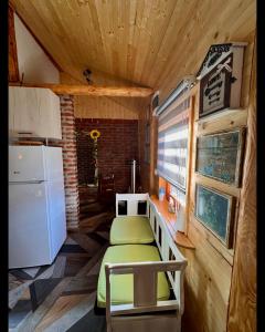 a small room with a bed and a refrigerator at Drveni san Senović 2 in Banja
