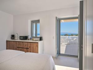 a bedroom with a bed and a view of a patio at Villa Katy in Aspro Chorio Paros +28 photos