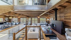 an open living room with wooden walls and ceilings at Luxury chalet - fireplace heated pool & sauna in Megève