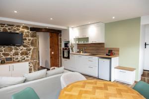 a living room with a white couch and a table at Le Clos de Narco in Vernosc-lès-Annonay