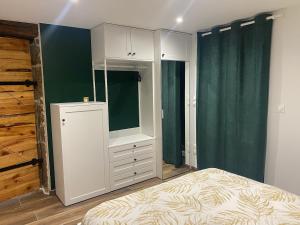 a bedroom with a bed and a dresser at Le Clos de Narco in Vernosc-lès-Annonay +11 photos