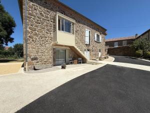 a stone building with a driveway in front of it at Le Clos de Narco in Vernosc-lès-Annonay