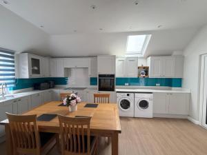 a kitchen with a wooden table and a dining room at Teran the apartment in Timsbury