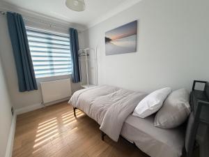 a bedroom with a bed and a window at Teran the apartment in Timsbury