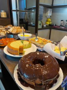 a table with a chocolate doughnut on top of it at Pousada Mel e Mar in Penha