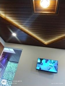 a flat screen tv on the ceiling of a room at Star Cottage DVM in Munnar