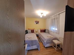 a small room with two beds and a window at Lavanda in Vukovar