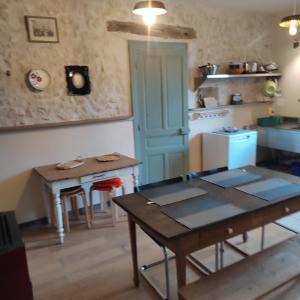 a kitchen with a table and a small table and a table sidx sidx at Gîte, Vintage Touch in Hannonville-sous-les-Côtes