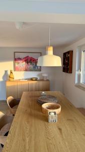 a dining room with a wooden table in a room at Designer chalet with gorgeous Eifel panorama in Kerschenbach