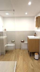 a bathroom with a sink and a toilet and a counter at Designer chalet with gorgeous Eifel panorama in Kerschenbach +15 photos