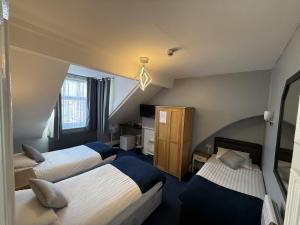 a hotel room with two beds and a window at Diamonds Guest House in York +47 photos