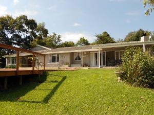 a house with a lawn in front of it at Chickpea Villa in Bergview