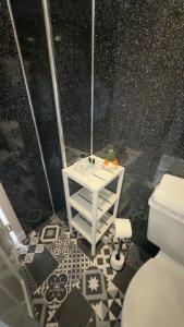 a bathroom with a toilet and a tiled floor at Fairwinds in Inverness