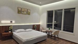 a bedroom with a bed and a table and chairs at Shri banke bihari complex in Jalesar