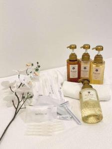 a group of three bottles of soap and towels at Hotel Arashi Nippombashi 1 No006 in Osaka