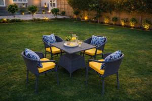a table and chairs in a yard with lights at Summit Springs Resorts in Bagru +2 photos