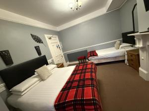 a hotel room with two beds in a room at Diamonds Guest House in York
