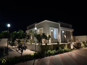 a home lit up at night with lights at Summit Springs Resorts in Bagru