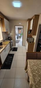 a kitchen with white cabinets and a large tile floor at Apartamento amplo, confortável e central! in Veranópolis +31 photos