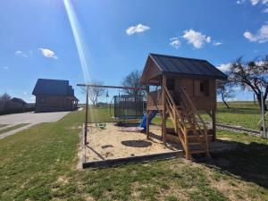 a playground with a play structure and a swing at Jodłowy domek na Roztoczu in Obrocz