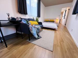 a living room with a couch and a table at KUROFUNE久我山ハウス,shibuya 13min,Kichijoji3min in Kugayama
