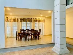 a dining room with a table and chairs at Sky Mansion Athurugiriya in Athurugiriya +13 photos
