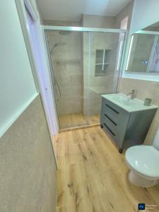 a bathroom with a shower and a toilet and a sink at Casa Del Sol in Águilas