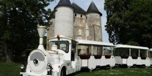 an old train is parked in front of a castle at Maison Anne face to park in Vernon Giverny in Vernon