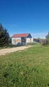 a house with a red roof in a field at Chalet à la campagne 40m2 in Charleval