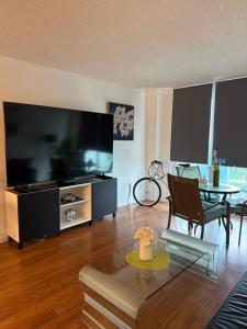 a living room with a large flat screen tv at Apartments TVG Miami by the ocean ! in Miami Beach