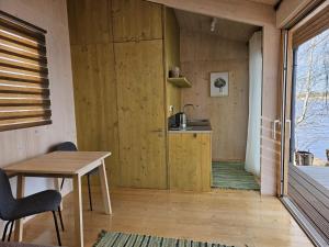 a room with a wooden door and a table at Piestātne Riverside Cabins with Sauna, Hot Tub & Private Pier in Katlakalns +57 photos