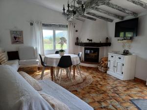 a living room with a table and a fireplace at Villa la Myreclose in Saint-Auban